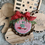 Thumbnail: A pink, red, white, and green Christmas tree cross stitched ornament by Mid-Century Maude