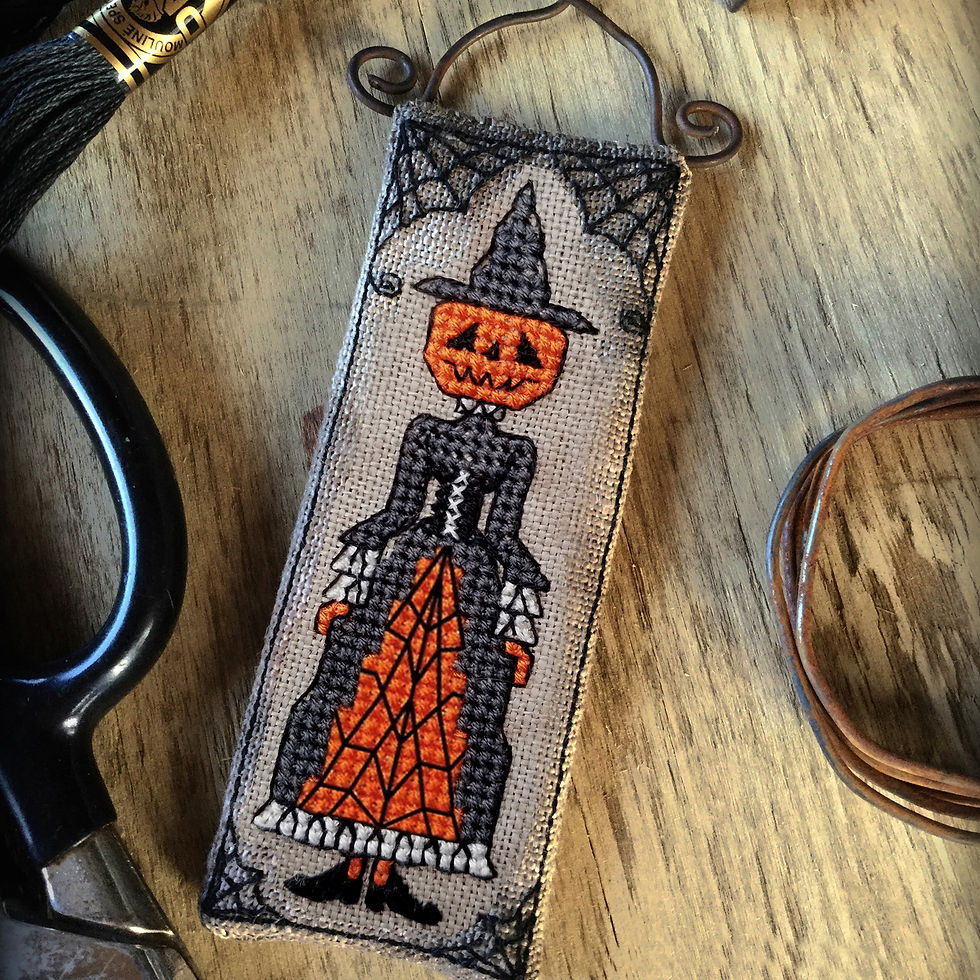 Halloween cross stitch kit for a Victorian pumpkin head witch on primitive rustic linen with metal hanger The Elfin Forest