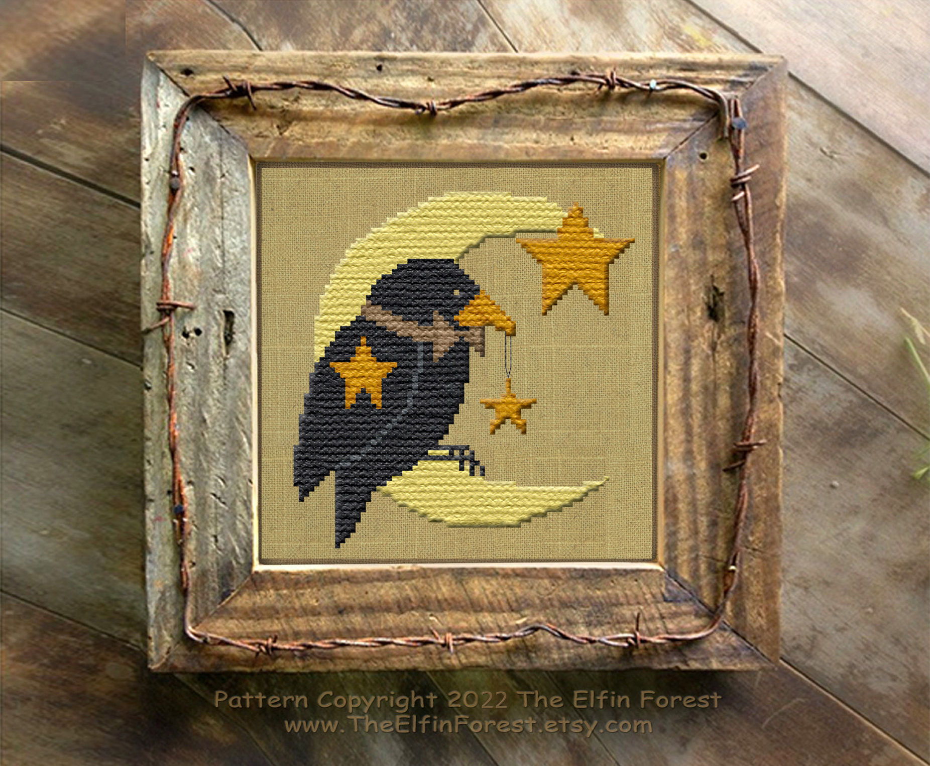 A stitched counted cross stitch pattern download of a primitive black crow moon and stars by The Elfin Forest