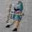 Thumbnail: an adorable elf embroidered in counted cross stitch on linen with the year 2022