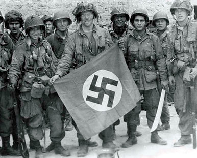  101st Airborne paratroopers showing a captured german nazi swastika in Marmion Farm
