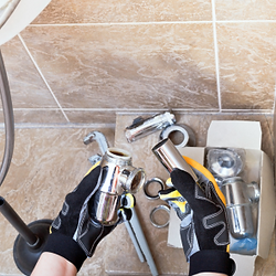 an image of hands holding a plumbing fixture