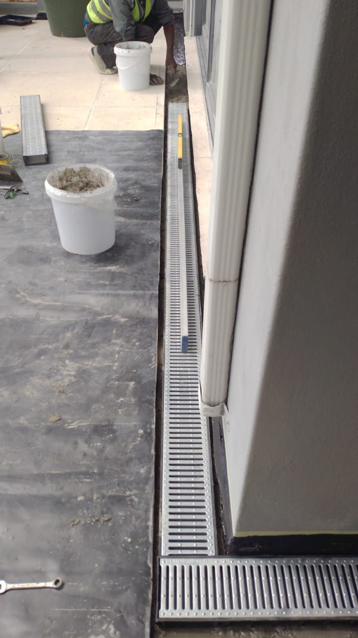 a storm water drain channel being installed and level being checked