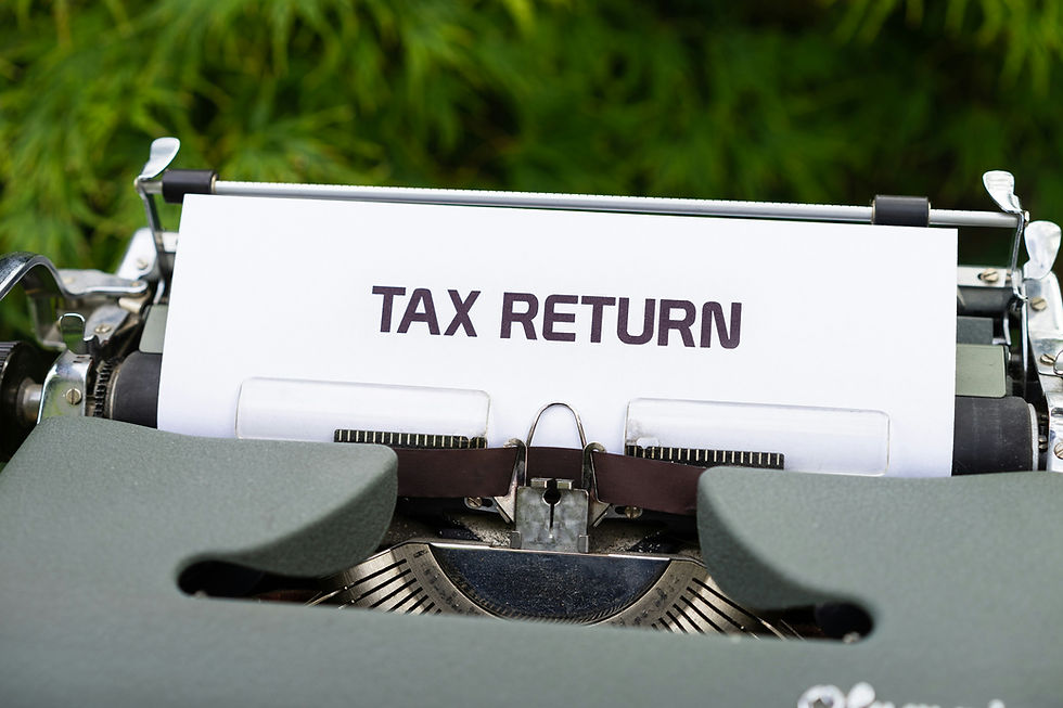 Tax return typed on white paper in a typewriter, with a blurred green background and a serious office mood.