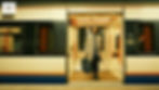 Woman in gray coat exits train, holding phone and bag. Train interior visible. Calm ambiance, warm lighting, train labeled "B1."