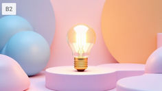 A glowing light bulb on a pastel pink platform surrounded by soft blue and orange spherical shapes; calm, creative atmosphere.