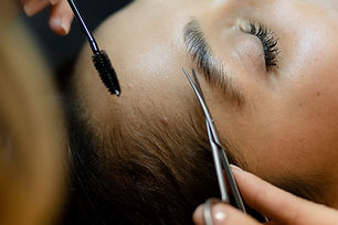 A Customer getting eyebrow treatment at a beauty salon.jpg