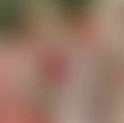 a tea cup with pink pudding, berries and mint leaves