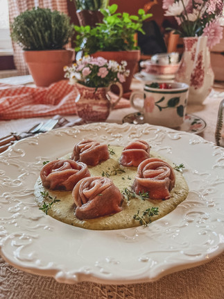 a plate of rose shaped pasta with a cozy spring like background