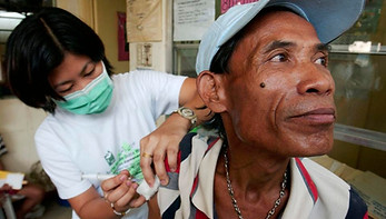 A tuberculosis patient is given a shot in one of the poorest neighborhoods which surrounds Metro-Manila's largest landfill. (Photo by David Greedy/Getty Images) GETTY IMAGES