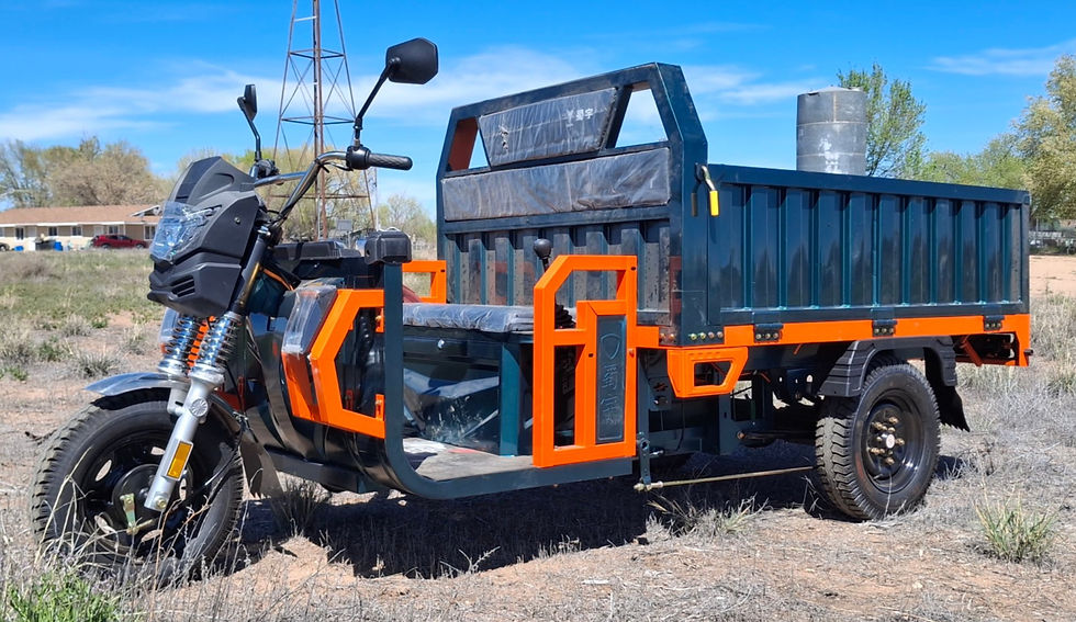 WorkOx WX6 Outlaw, a green and orange three wheel electric utility truck set in a grass field