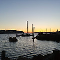 Golden sunset over the Carquinez Strait in Benicia, featuring the Alfred Zampa Memorial Bridge and the iconic sunken ship