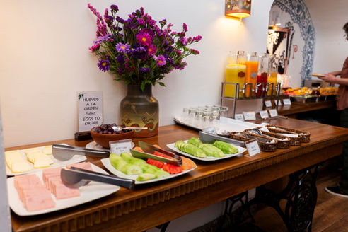 Buffet breakfast served in a colonial-style dining room at Boutique Hotel Rumi Punku in Cusco, Peru