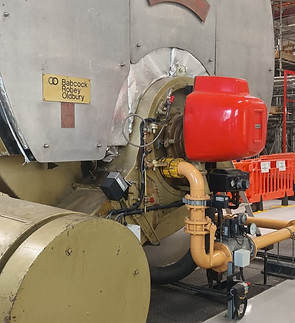 Large industrial commercial boiler with piping systems.
