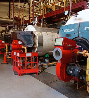 Commercial boiler units in a furnace room.