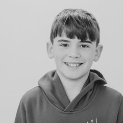 Boy looking at camera in solid background and black and white image