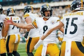 Aaron Rodgers celebrates with Pittsburgh Steelers teammates.
