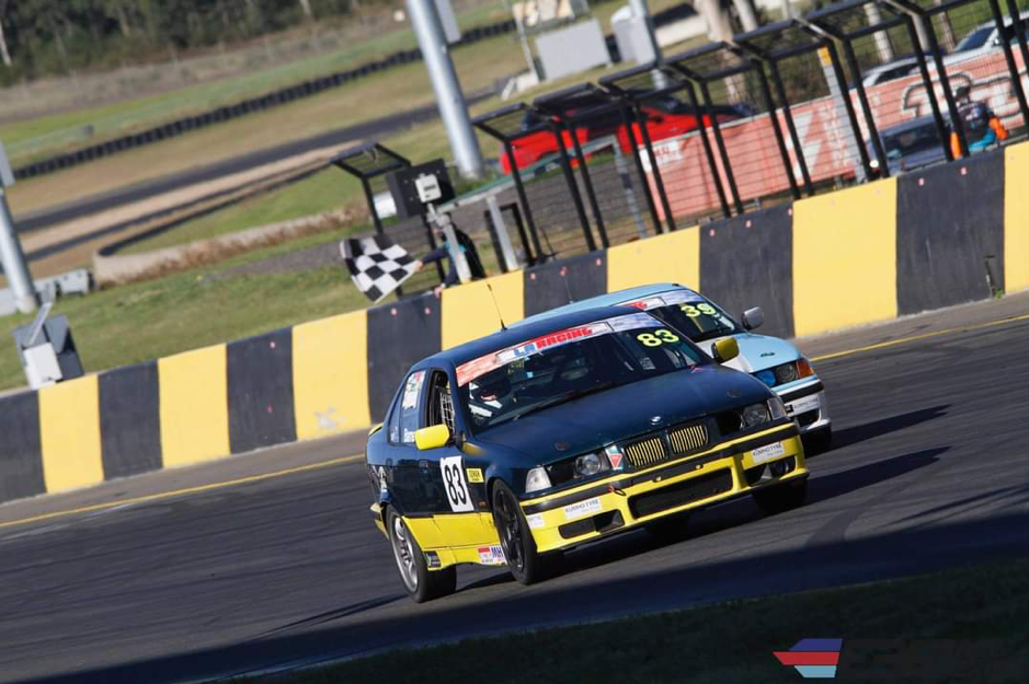 Jeff Barnes in his race car crossing the line at Sydney Motorsport Park.