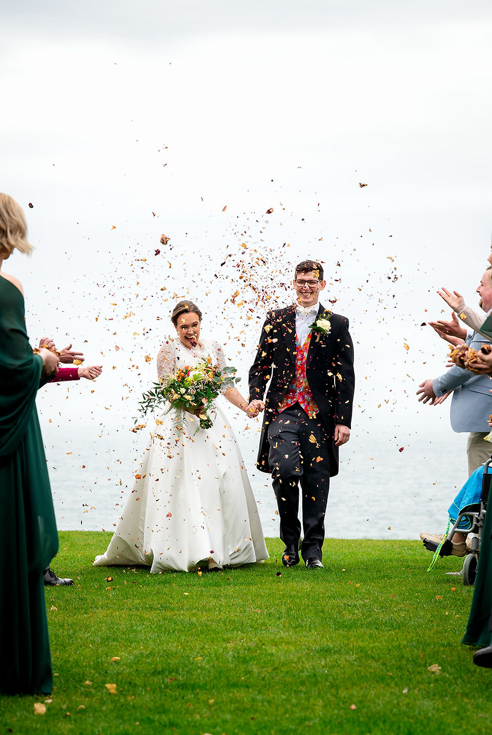 Confetti moment outside Polhawn Fort after the wedding ceremony