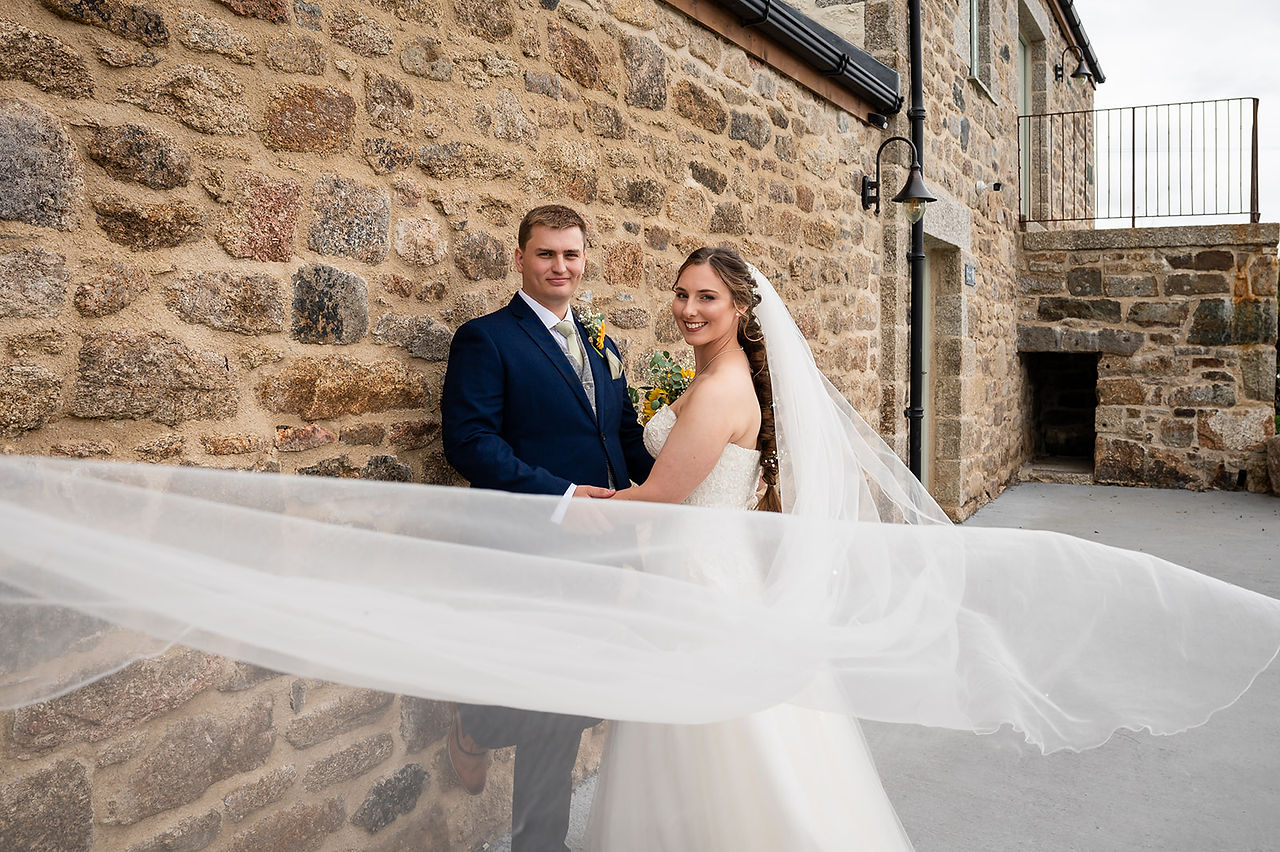 Bride and groom veil flowing in the breeze at Avalen Farm