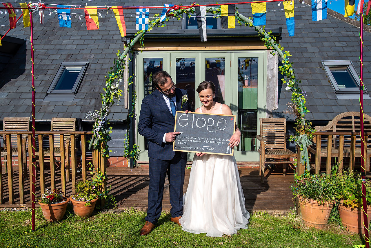 Bride and groom look at their Elope in Cornwall