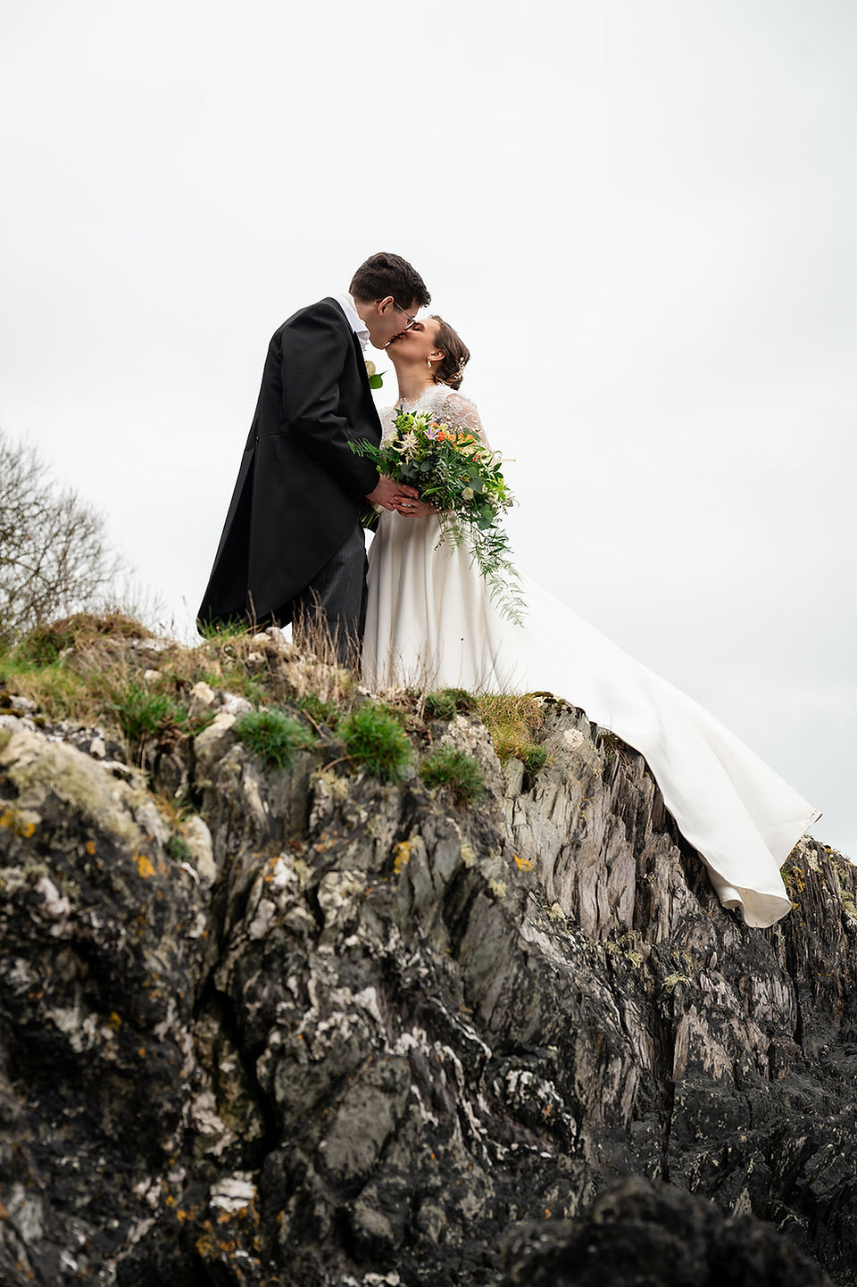 Newlyweds enjoying cliffside portraits at Polhawn Fort
