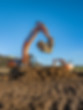 An excavator moving materials for a civil engineering project.