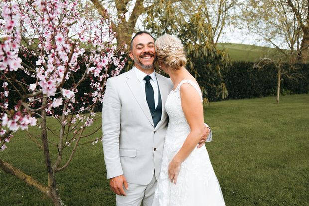 A couple hugging and smiling on their wedding day. Beautiful garden wedding, Lake Karipiro/Cambridge