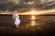 Beautiful golden hour maternity photo taken by the water