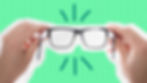Hands holding up pair of glasses