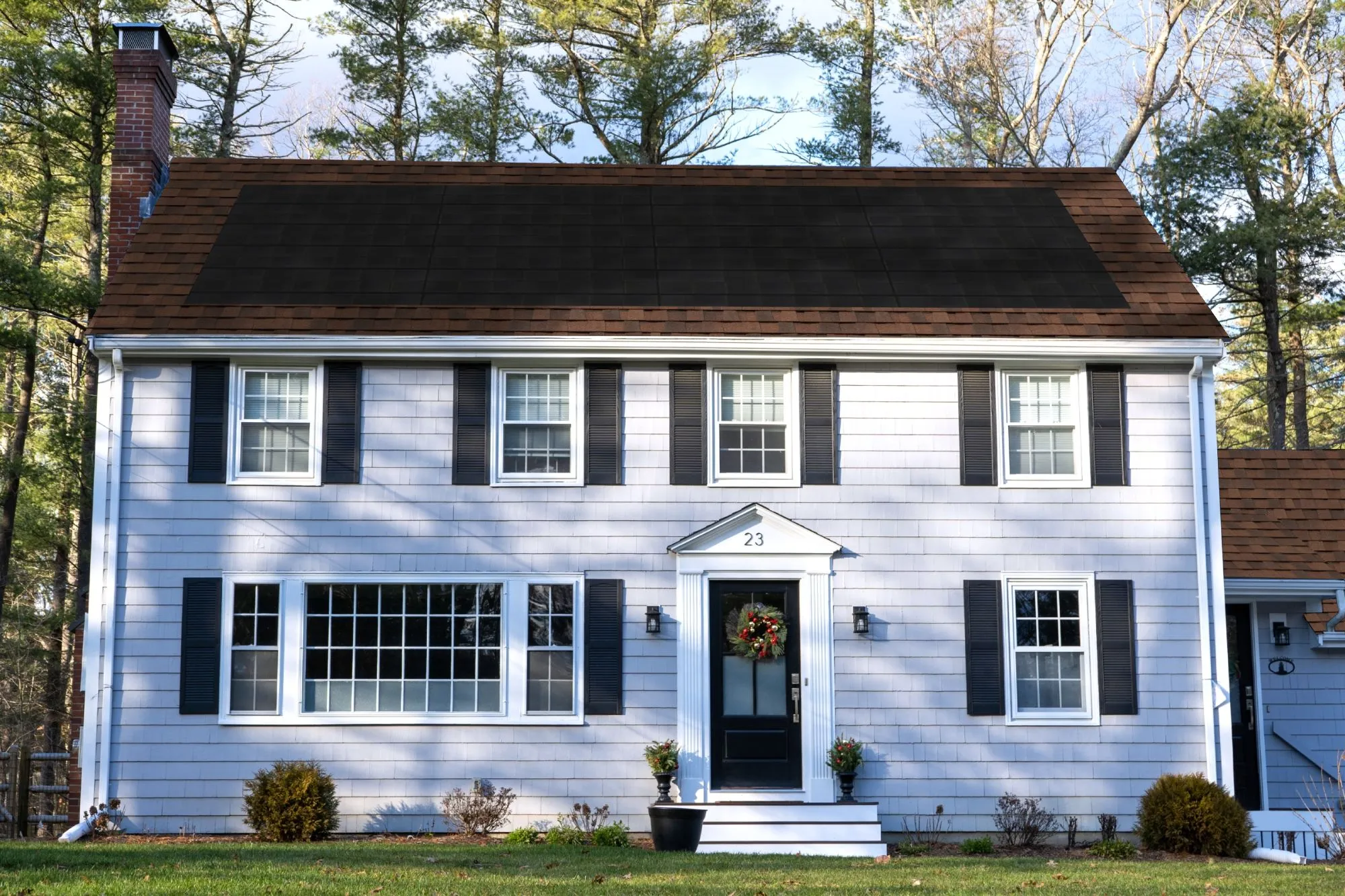 Colonial-style home mockup from the CertainTeed solar shingle color selector tool, showing a Burnt S
