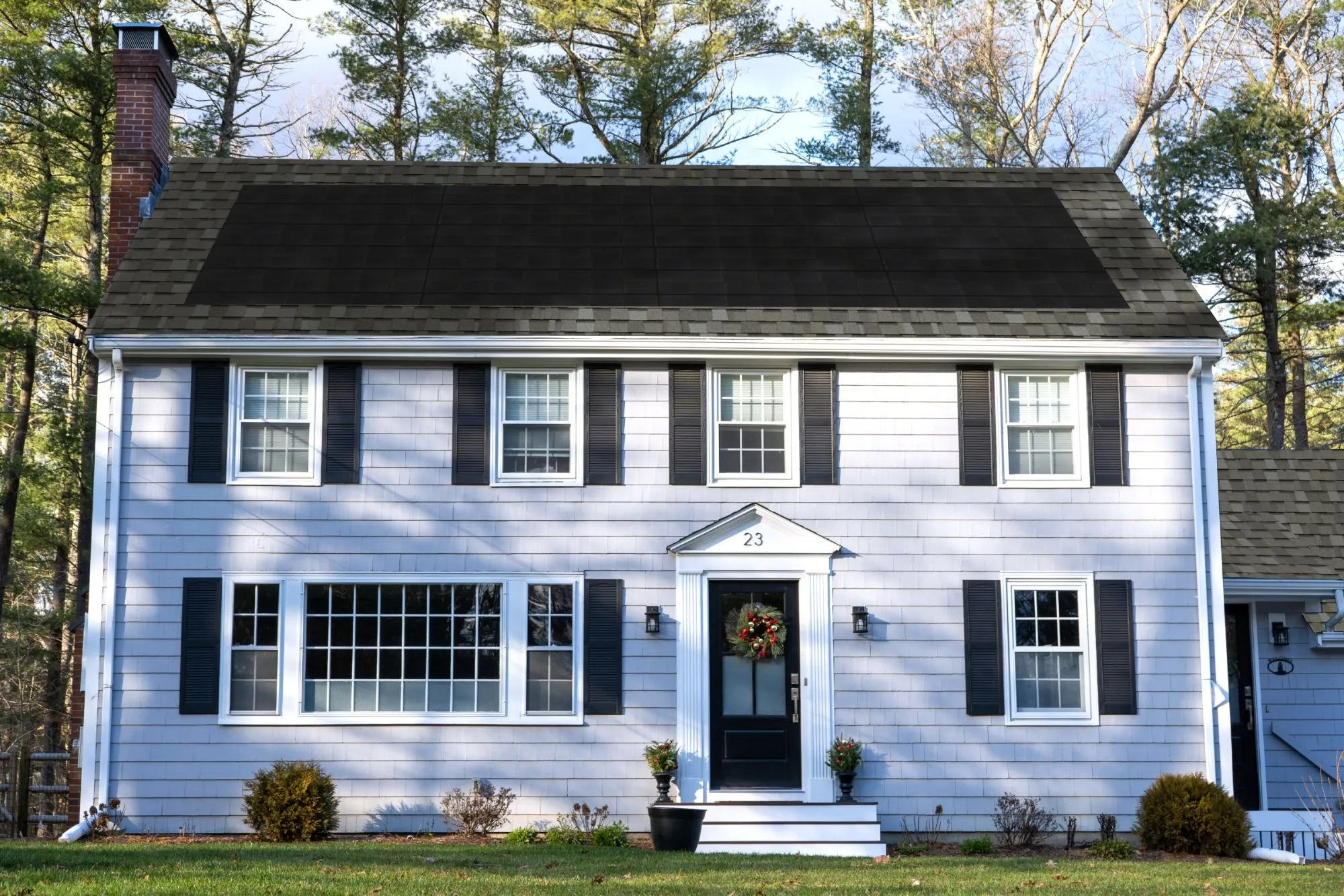 Colonial-style home mockup from the CertainTeed solar shingle color selector tool, showing a light g
