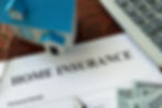 A home insurance policy shown on a desk
