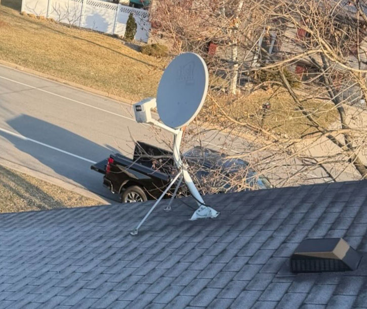Unused Satellite dish on an asphalt roof in Verona, WI