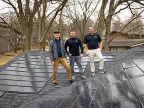 Sun Vault Roofing team standing on completed solar shingle roof installation in Wisconsin