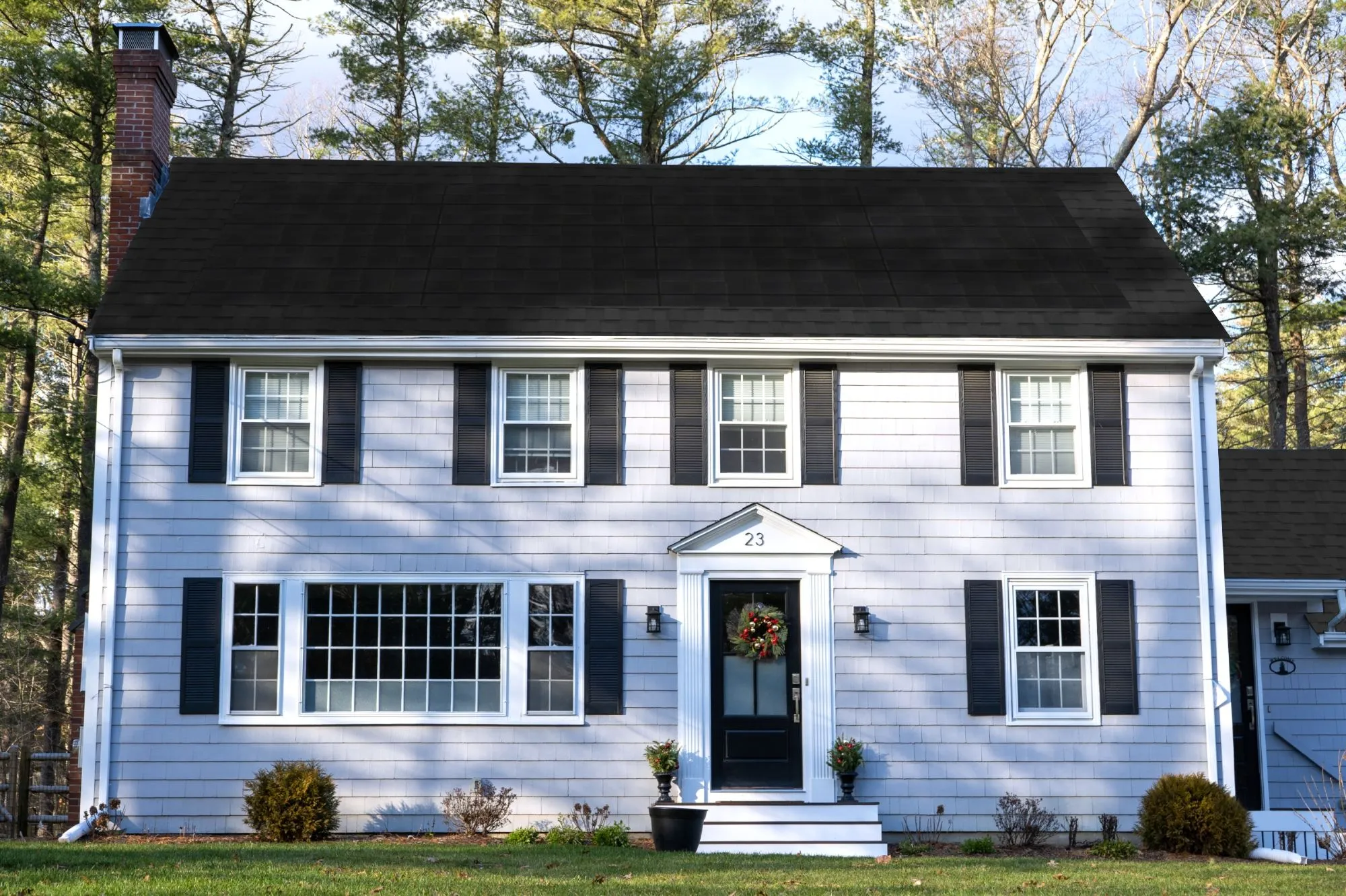 Colonial-style home mockup from the CertainTeed solar shingle color selector tool, showing a Moire B