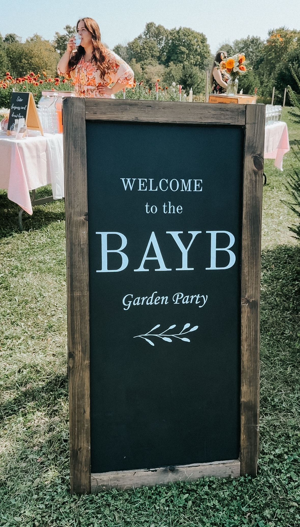 Wooden chalkboard sign with the words 
