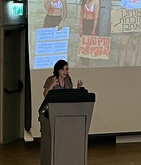 a women lecturing in a formal setting of an academic conference