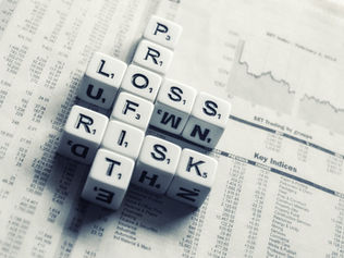 Dice spelling out profit, loss and risk. 