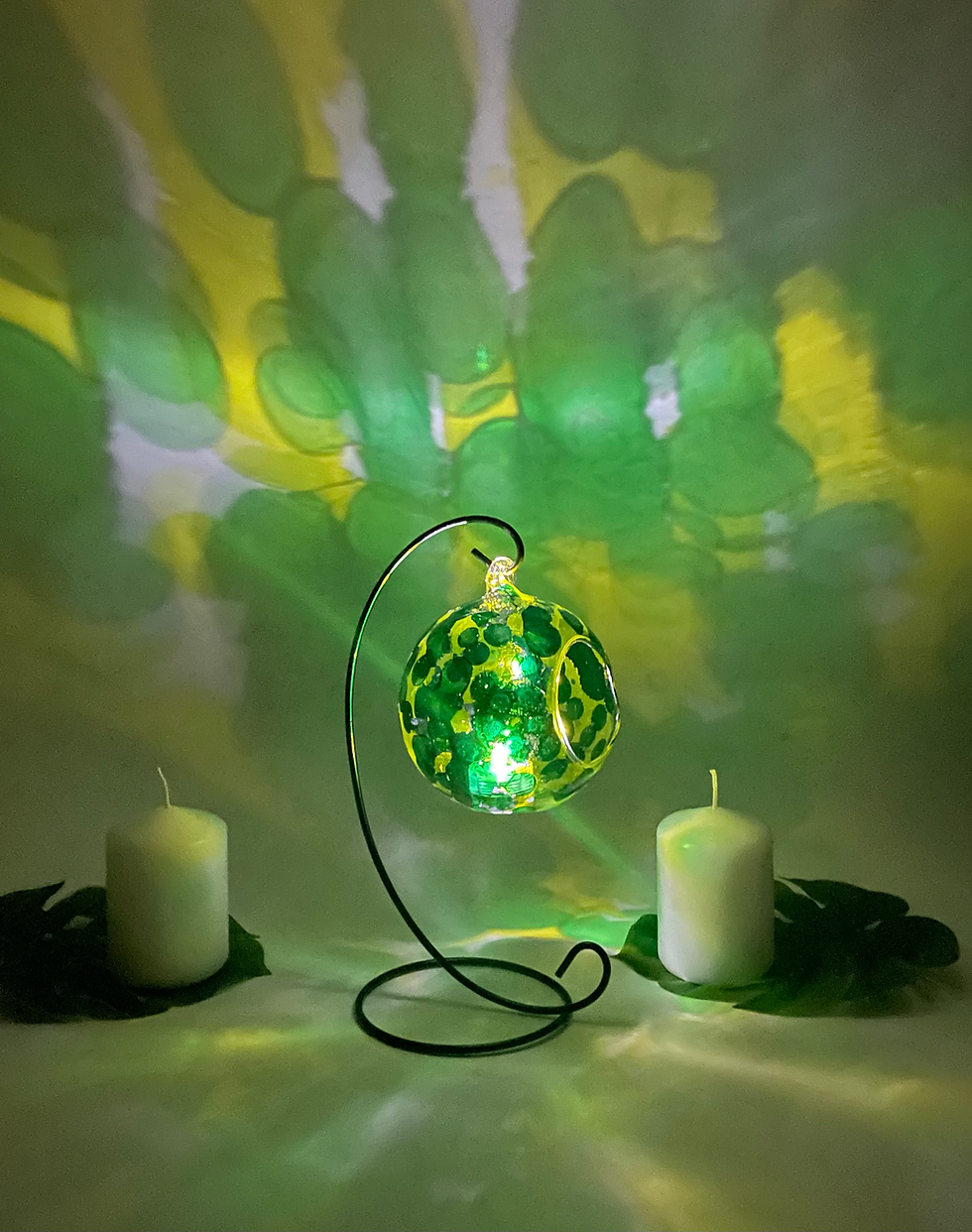 Thumbnail: Bright and colorful, a candle holder thais simple yet effectively decorated in an abstract design of green and yellow