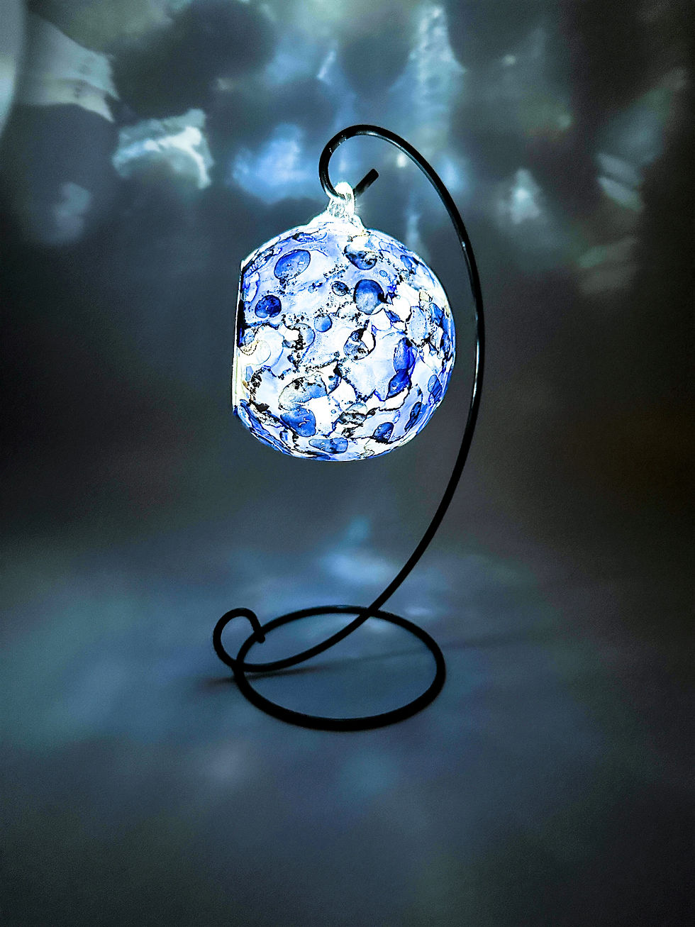 Thumbnail: Interesting and unique, this glass candle holder is hand painted in shades of blue, pearl and copper