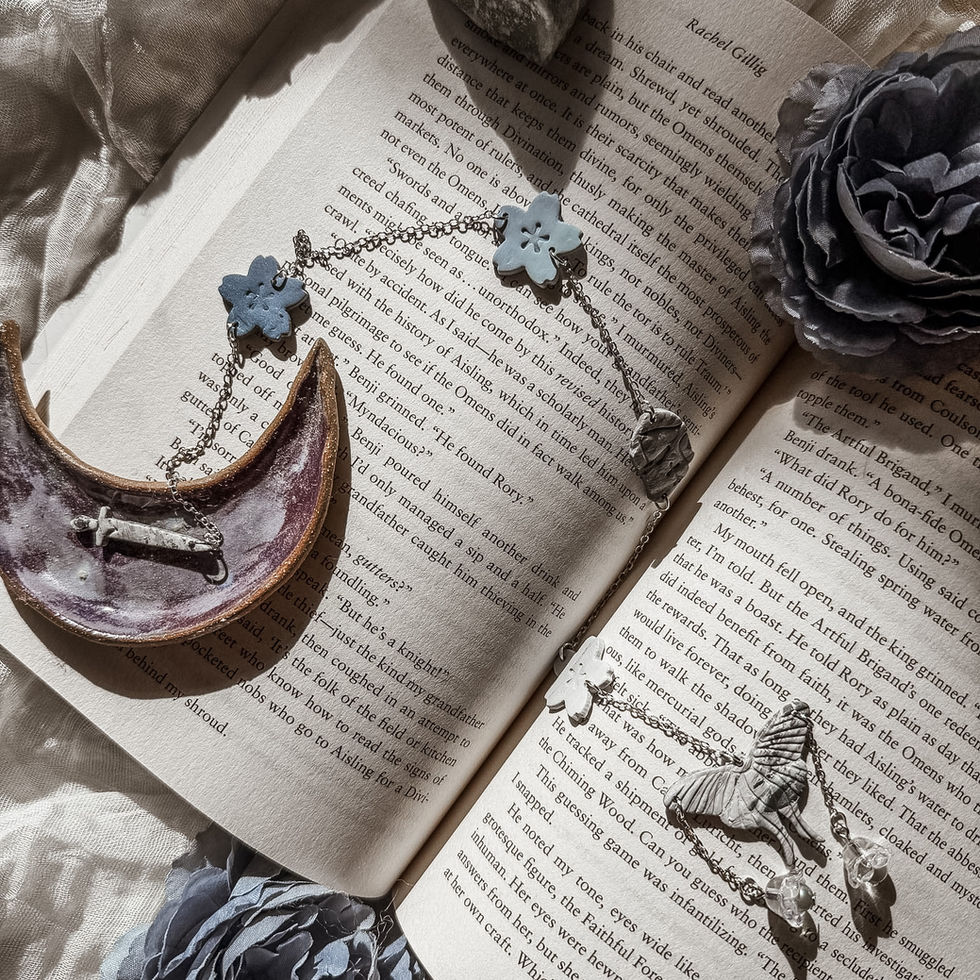 original Moonlit Wing bookmarks laid on top of an open book