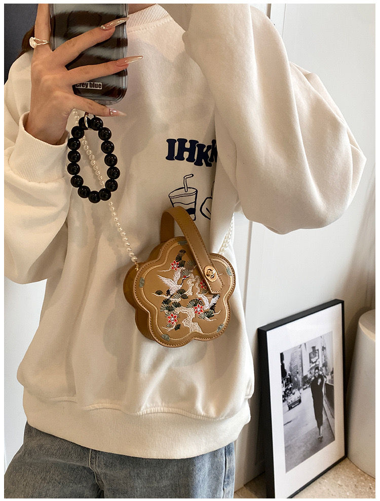 Thumbnail: Vintage-Inspired Embroidered Crossbody Bag This charming vintage-inspired bag