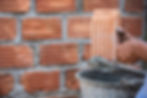 masonry-worker-outside-wall-with-trowel-knife.jpg