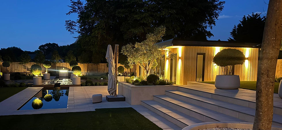 Luxury steel frame garden room at night.