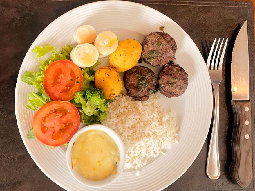 Prato: Escondidinho de carneiro, batatas, almôndegas, palmito, arroz e salada. / Foto: Divulgação.