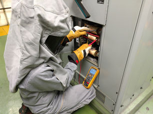 a qualified electrical worker checking for absence of voltage