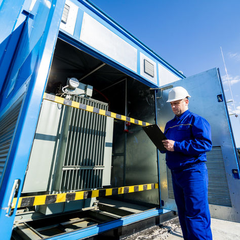 electrical technician evaluating the power transformer