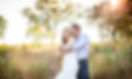 The groom wraps his arms around his bride from behind and leans his head against hers on North Ave Beach in Chicago, IL.