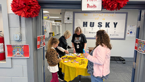 Students picking from a photo booth prop.
